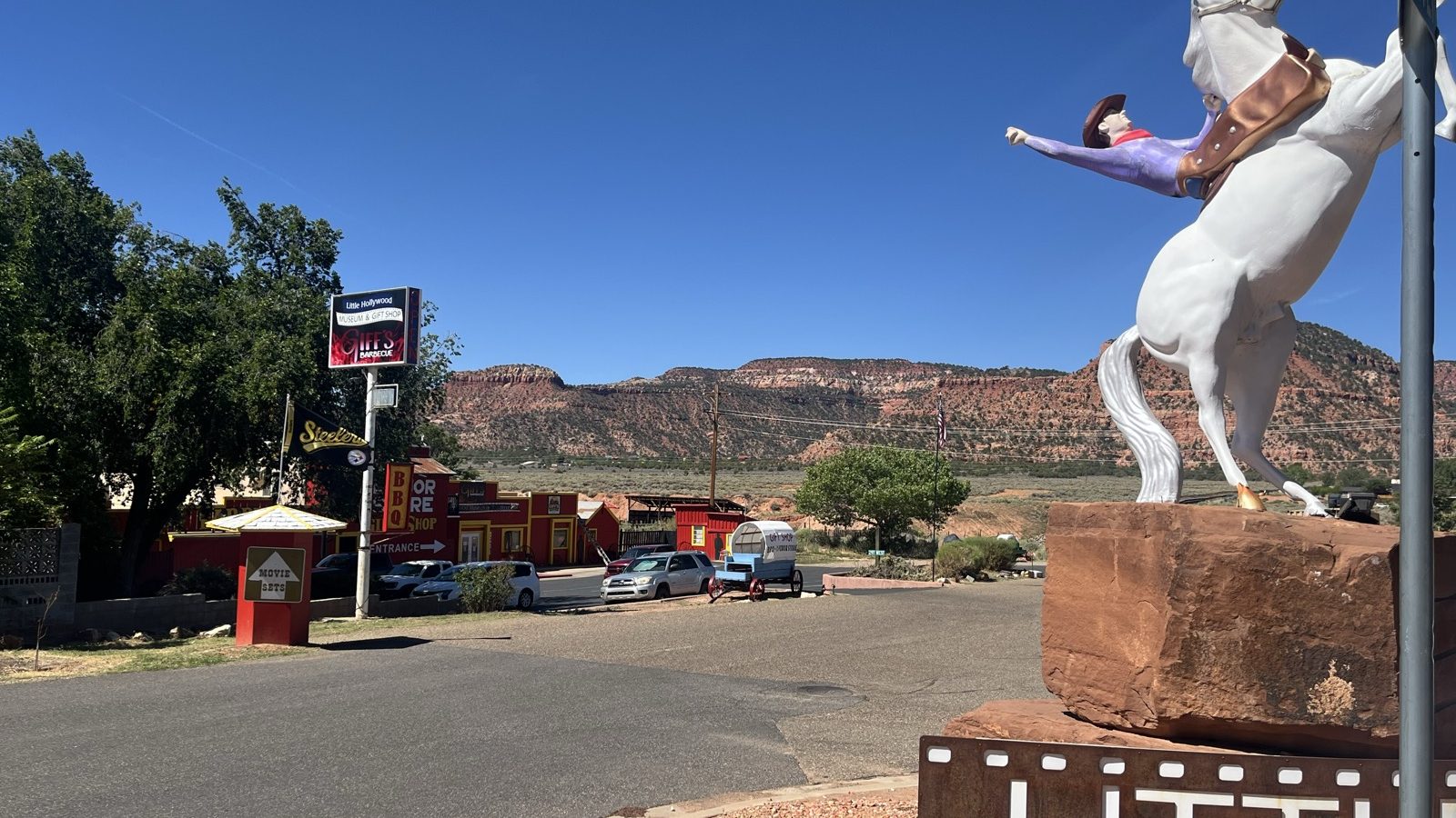 The Little Hollywood grounds in Kanab with the white horse statue and red rock behind