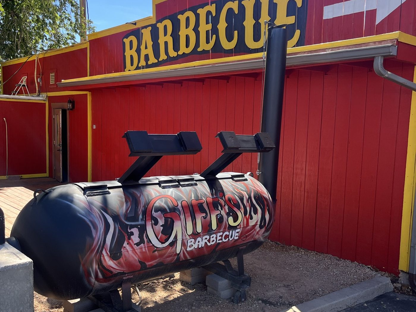 Giff's custom offset smoker outside the red barbecue building in Kanab
