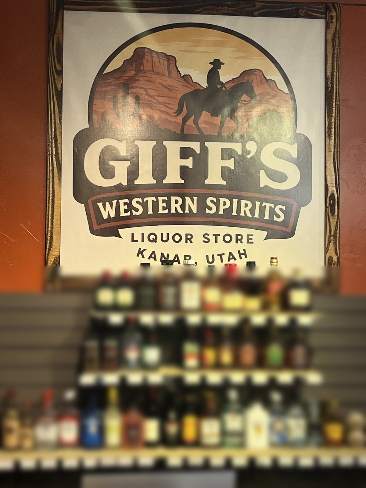 The Giff's Western Spirits sign inside the store, showing a rider on horseback below red rock mesas