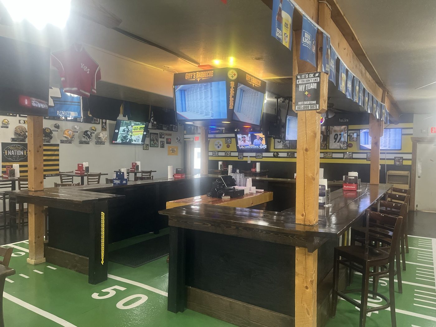 The Steelers room at Giff's with the football-field floor and televisions