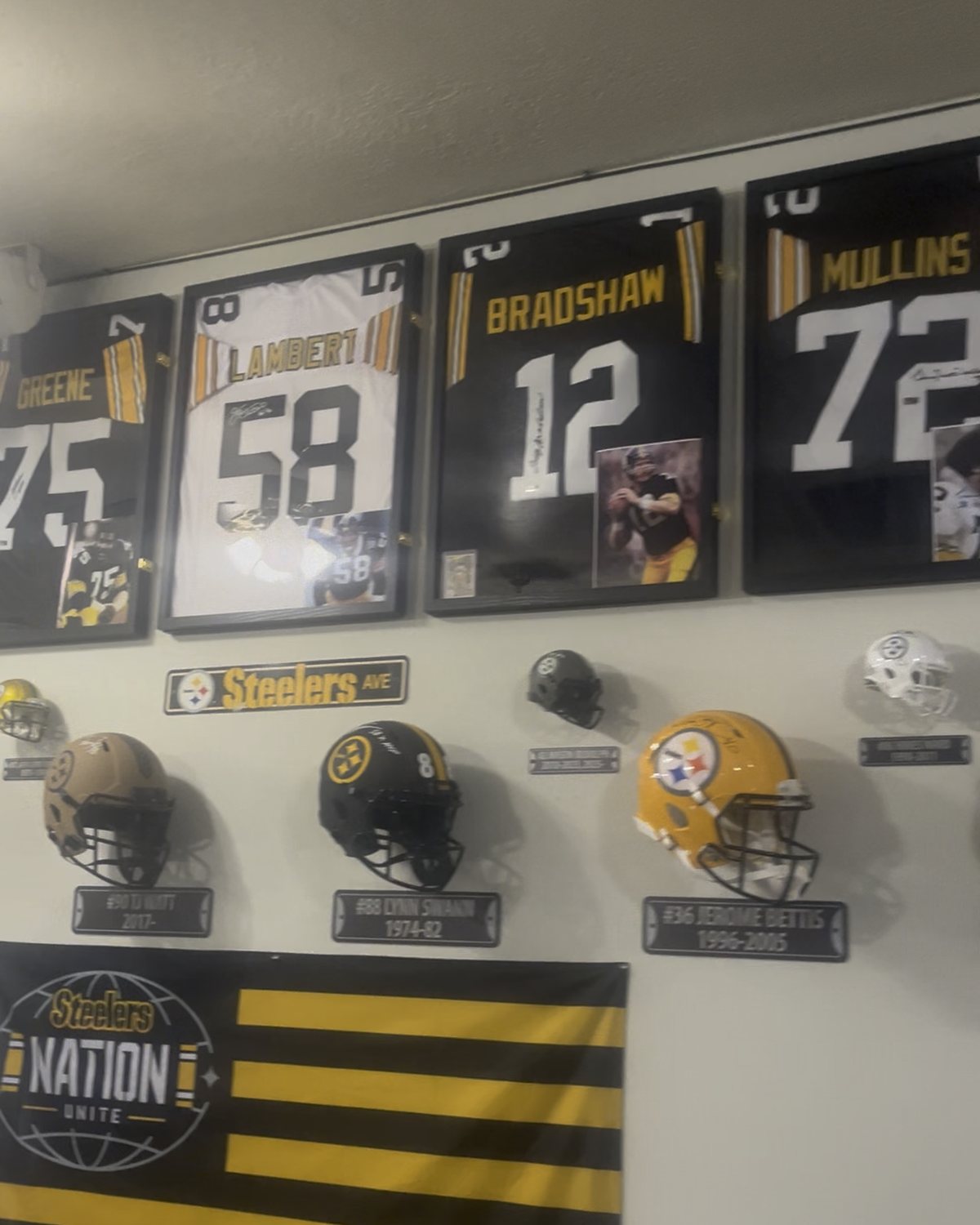 Framed Steelers jerseys, helmets and a Steelers Nation Unite banner on the wall at Giff's Barbecue